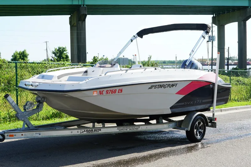Slide: The Image of 2017 Starcraft Star Step 221 OB boat on trailer under bridge. - 4