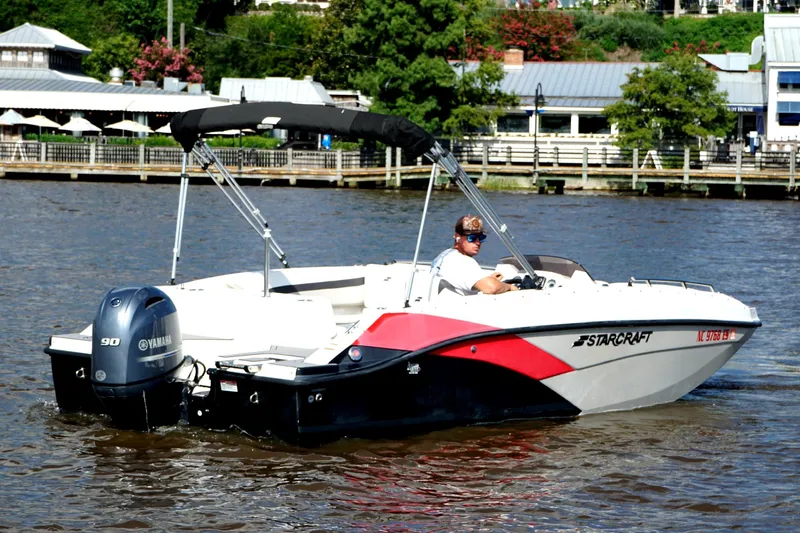 Slide: The Image of 2017 Starcraft Star Step 221 OB boat cruising on a river with Yamaha engine. - 8
