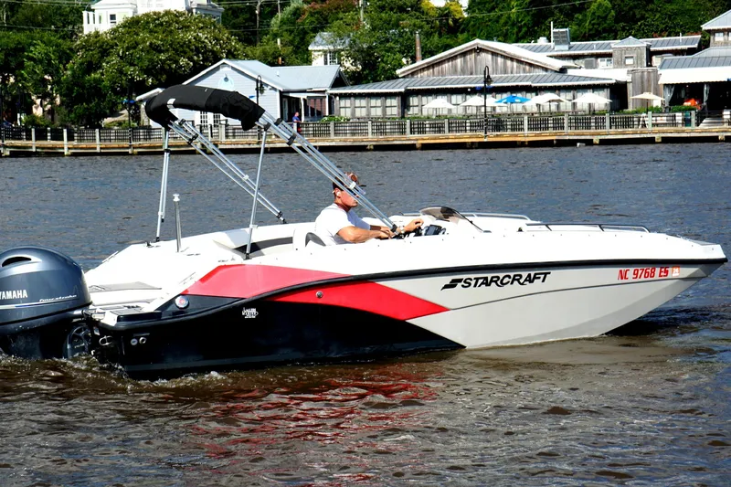 Slide: The Image of 2017 Starcraft Star Step 221 OB boat cruising on a river with Yamaha outboard motor. - 9