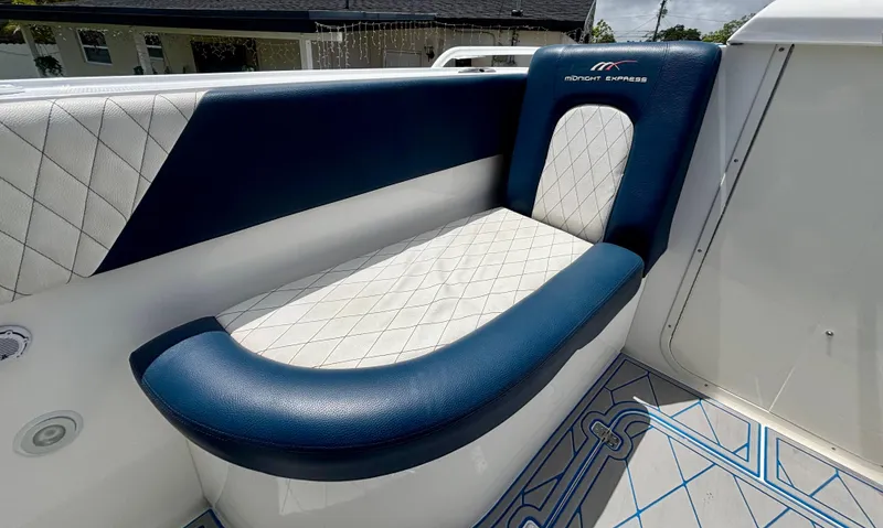 Slide: The Image of Luxurious seating on a 2007 Midnight Express 39 Cuddy boat, featuring blue and white upholstery. - 11