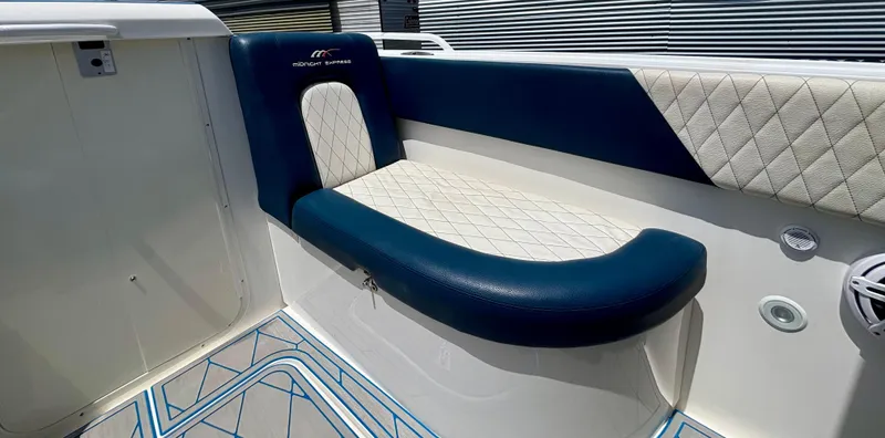 Slide: The Image of Luxurious seating on a 2007 Midnight Express 39 Cuddy boat with blue and white upholstery. - 12