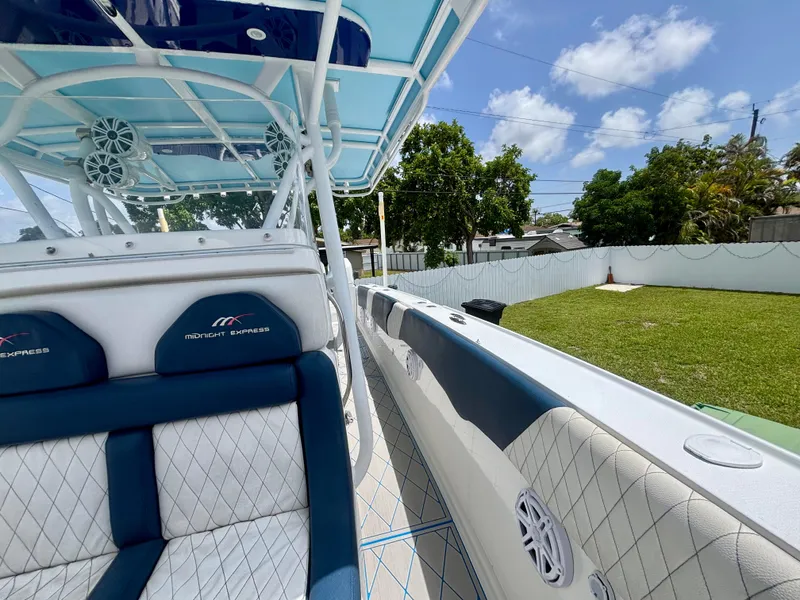Slide: The Image of 2007 Midnight Express 39 Cuddy boat interior with blue and white seating, outdoor setting. - 15
