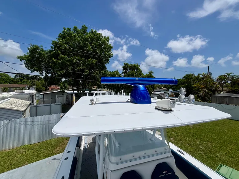 Slide: The Image of 2007 Midnight Express 39 Cuddy boat with radar, set against a clear blue sky. - 17