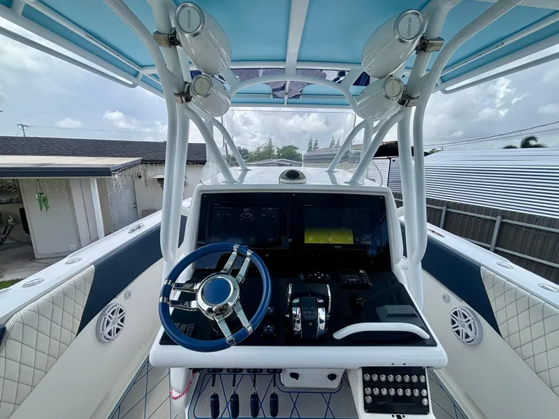 Slide: The Image of 2007 Midnight Express 39 Cuddy boat helm with modern controls and blue accents. - 18