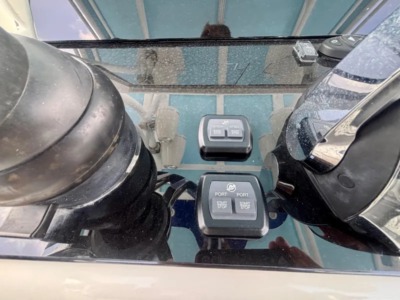Slide: The Image of Control panel of a 2007 Midnight Express 39 Cuddy boat with start/stop buttons. - 23