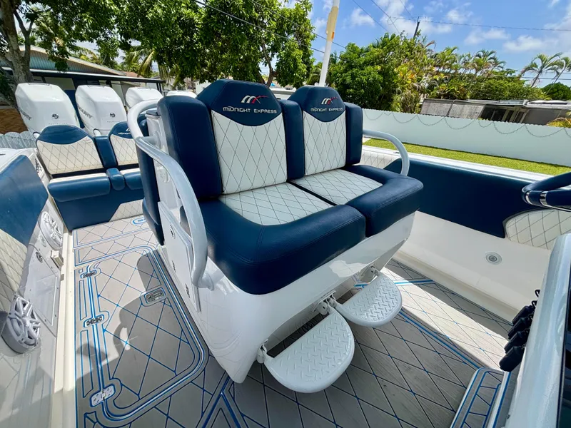 Slide: The Image of 2007 Midnight Express 39 Cuddy boat interior with blue and white seating, outdoor setting. - 28