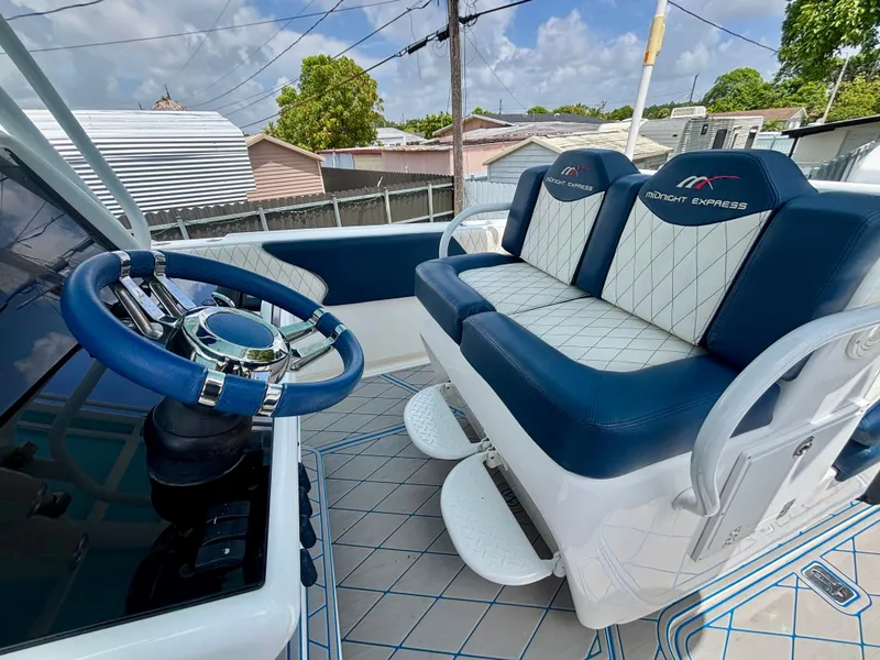 Slide: The Image of 2007 Midnight Express 39 Cuddy boat interior with blue and white seating and steering wheel. - 29