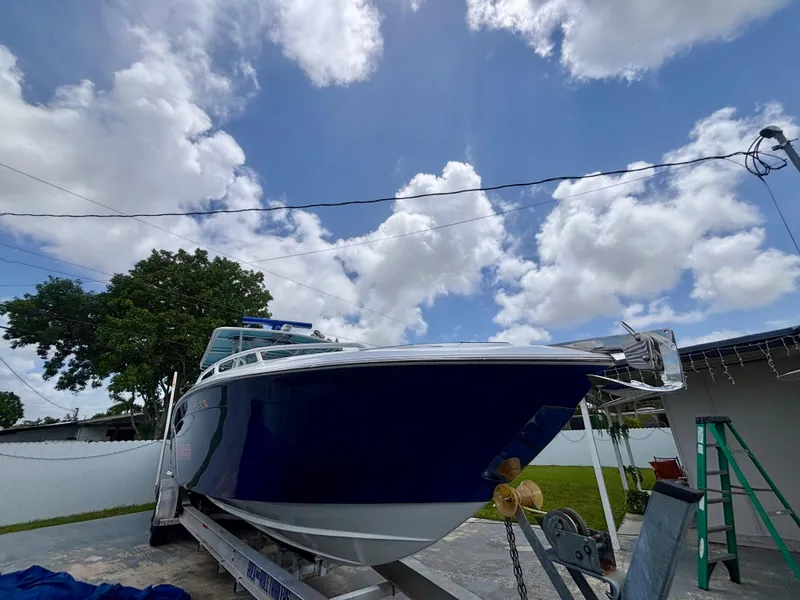 Slide: The Image of 2007 Midnight Express 39 Cuddy boat on trailer under a partly cloudy sky. - 3