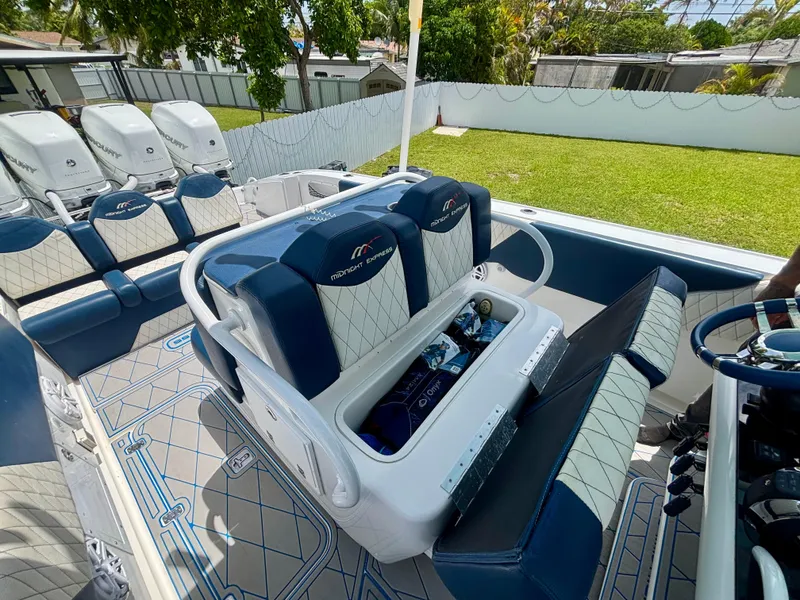 Slide: The Image of 2007 Midnight Express 39 Cuddy boat interior with blue and white seating and storage compartment. - 30