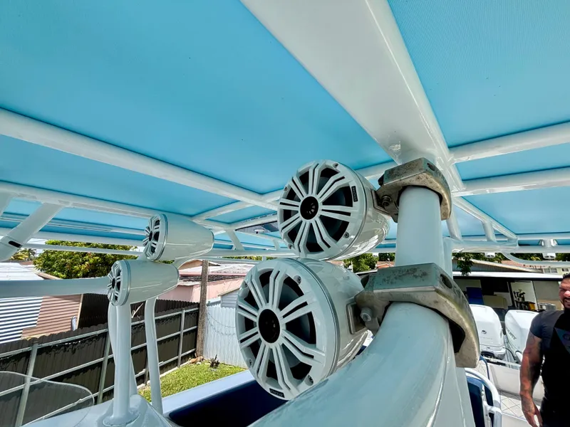 Slide: The Image of Speakers mounted on a 2007 Midnight Express 39 Cuddy boat with blue canopy. - 31