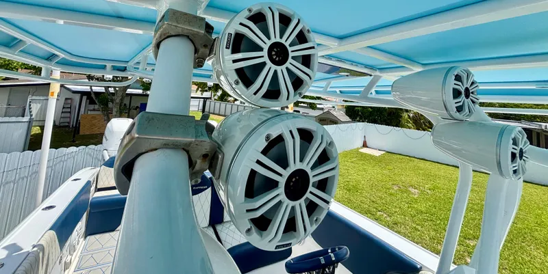 Slide: The Image of Speakers mounted on a 2007 Midnight Express 39 Cuddy boat, featuring a blue canopy. - 32