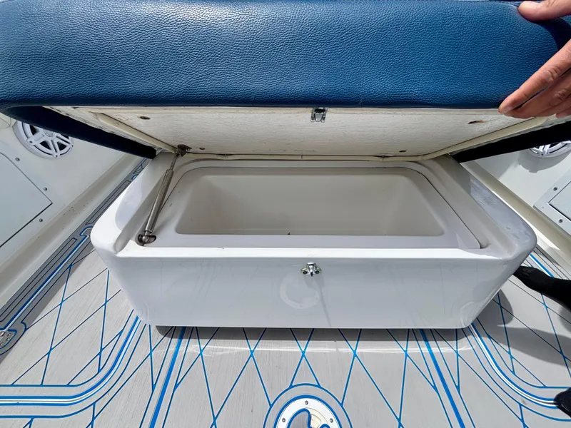 Slide: The Image of Open storage compartment on 2007 Midnight Express 39 Cuddy boat with blue cushioned lid. - 34