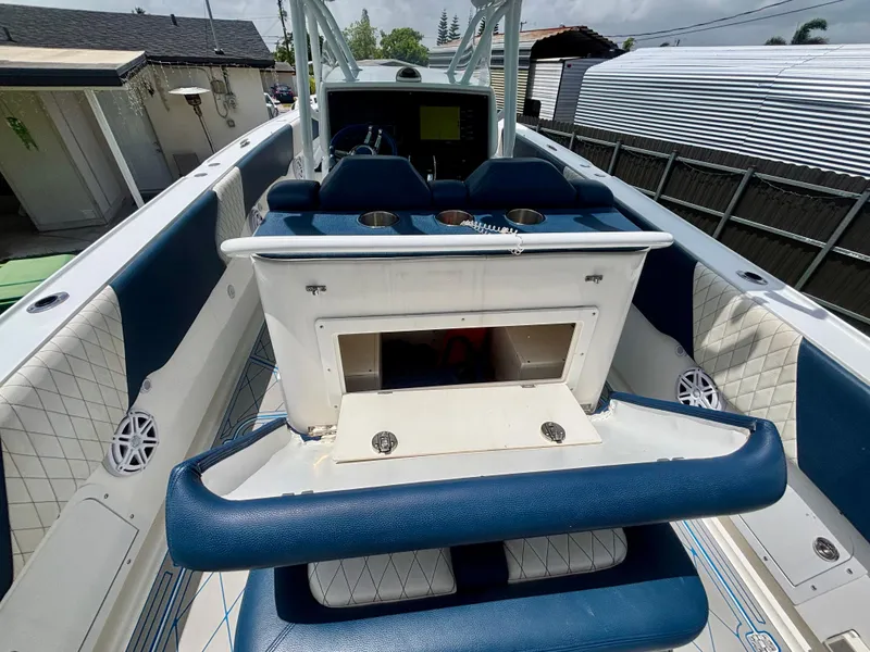 Slide: The Image of 2007 Midnight Express 39 Cuddy boat interior with blue seating and storage compartment. - 35