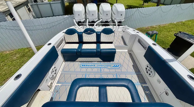 Slide: The Image of 2007 Midnight Express 39 Cuddy boat interior with seating and four outboard engines. - 40
