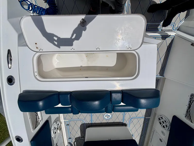 Slide: The Image of 2007 Midnight Express 39 Cuddy boat interior with open storage compartment and blue seating. - 42