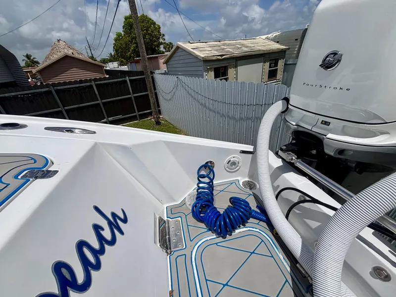 Slide: The Image of 2007 Midnight Express 39 Cuddy boat with outboard motor and coiled blue hose. - 43