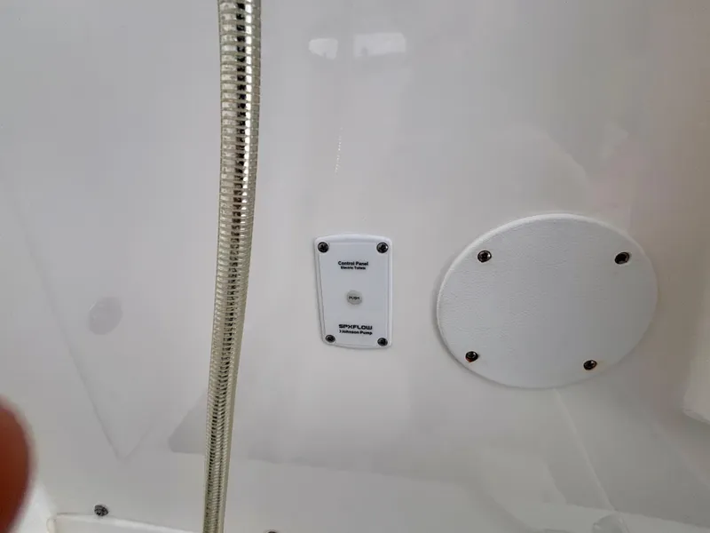 Slide: The Image of Control panel and hose on 2007 Midnight Express 39 Cuddy boat interior. - 49