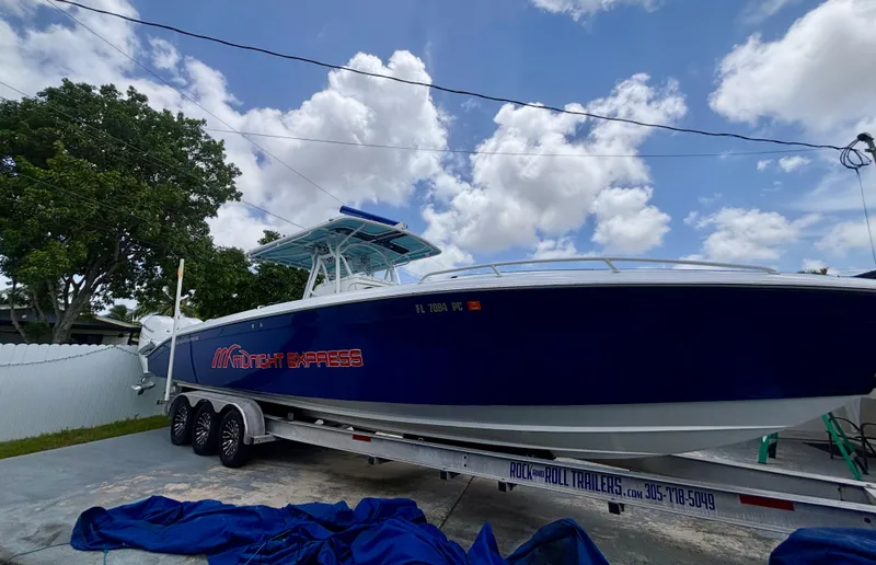 Slide: The Image of 2007 Midnight Express 39 Cuddy boat on trailer under blue sky. - 5