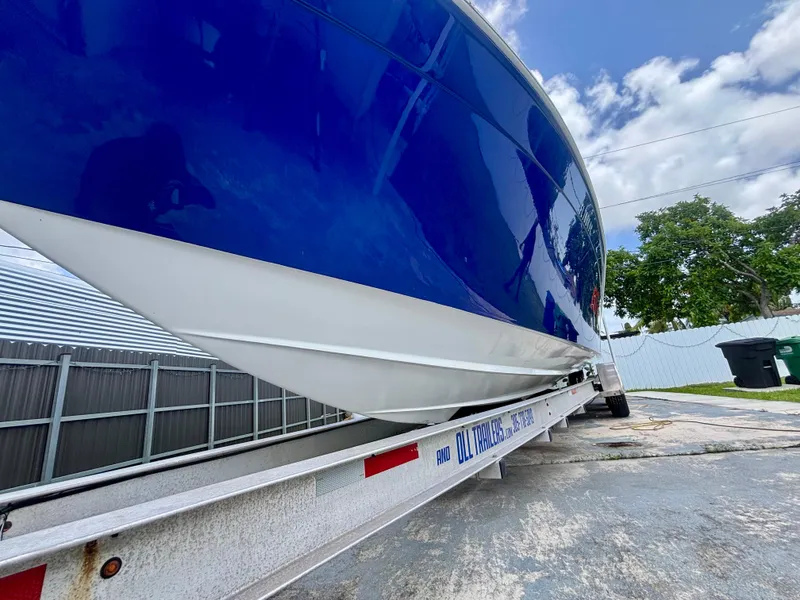 Slide: The Image of 2007 Midnight Express 39 Cuddy boat on trailer, blue hull, outdoor setting. - 6