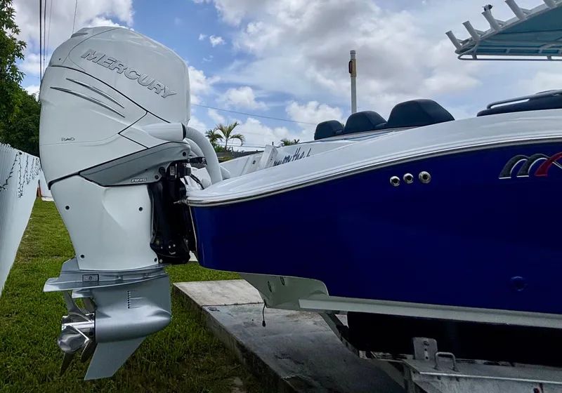 Slide: The Image of 2007 Midnight Express 39 Cuddy with Mercury outboard engine, docked on grass. - 7
