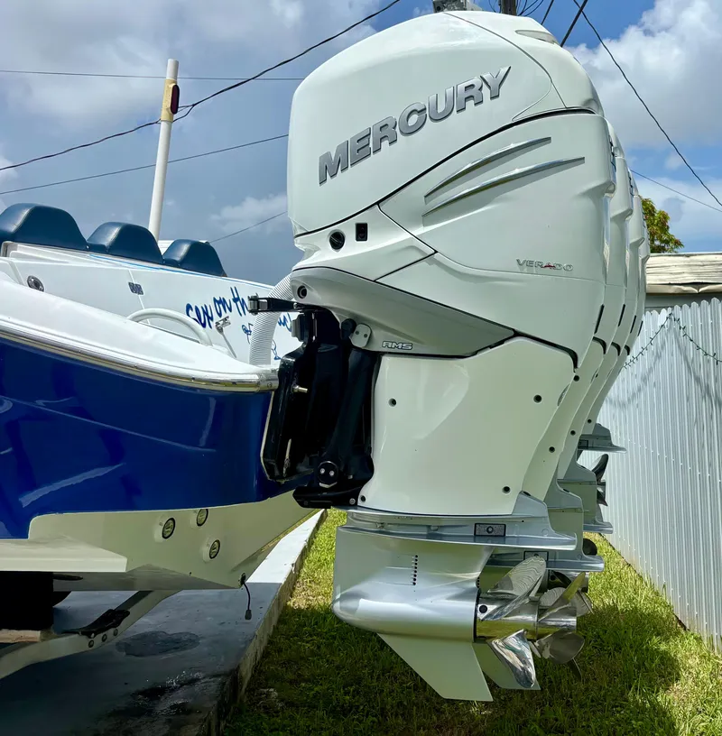 Slide: The Image of 2007 Midnight Express 39 Cuddy with Mercury outboard engines, docked on grass. - 8