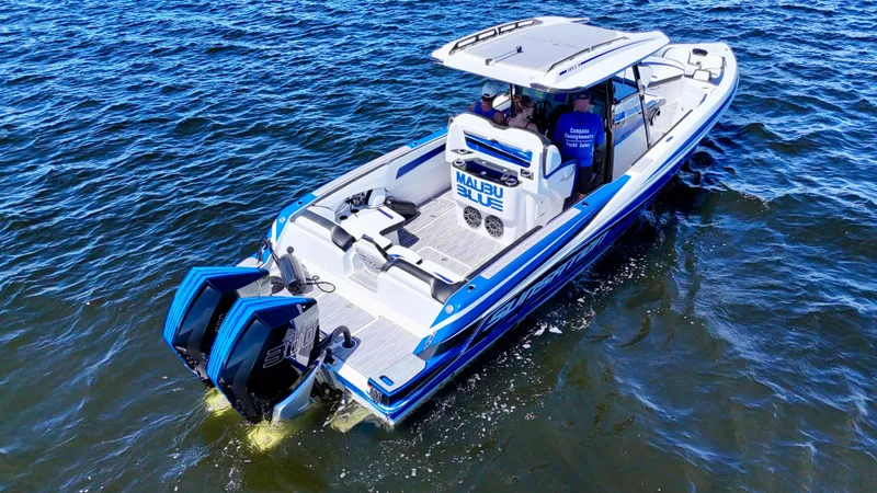 Slide: The Image of 2023 Sunsation 32 CCX boat on water, featuring dual engines and sleek design. - 11