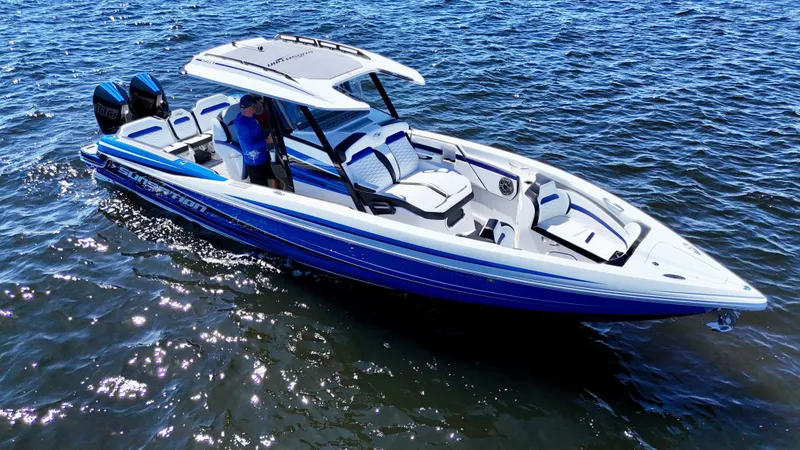 Slide: The Image of 2023 Sunsation 32 CCX boat on water, featuring sleek design and dual engines. - 12