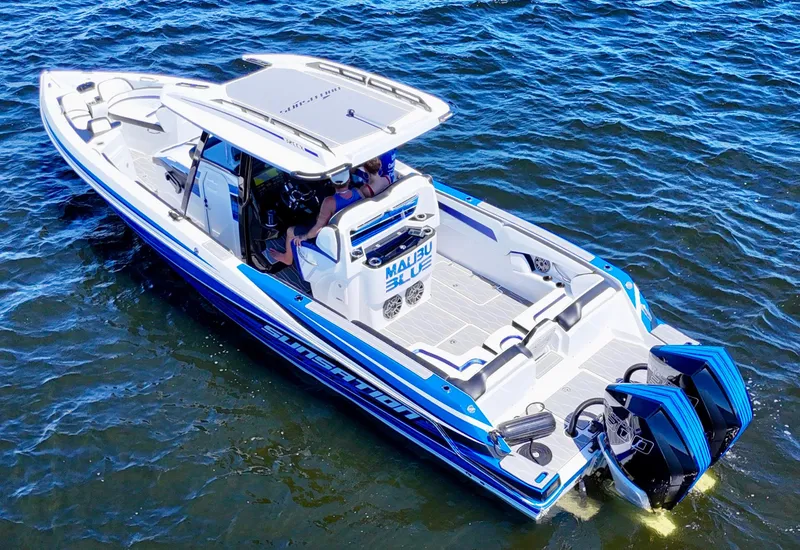 Slide: The Image of 2023 Sunsation 32 CCX boat on water, featuring sleek design and powerful engines. - 14