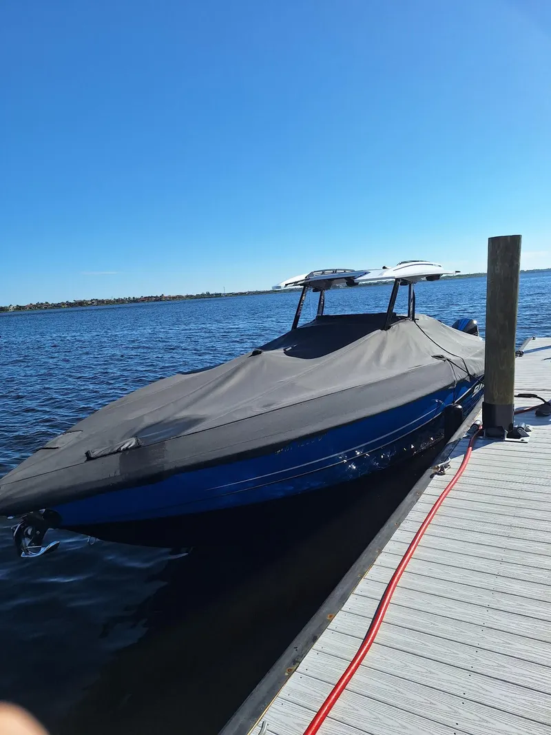 Slide: The Image of 2023 Sunsation 32 CCX boat covered at dock on a sunny day. - 17
