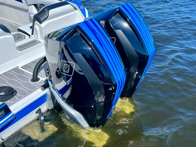 Slide: The Image of 2023 Sunsation 32 CCX boat with dual outboard engines on water. - 20