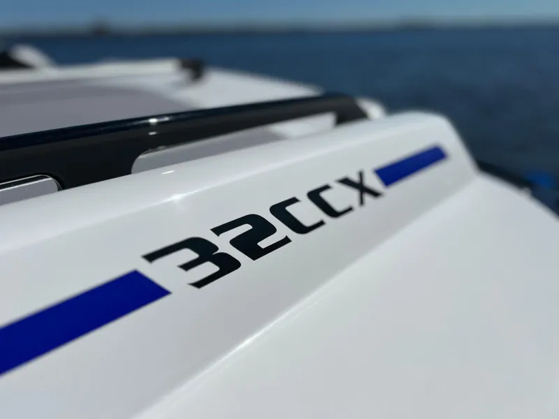 Slide: The Image of 2023 Sunsation 32 CCX boat detail with logo, on a sunny day at sea. - 23