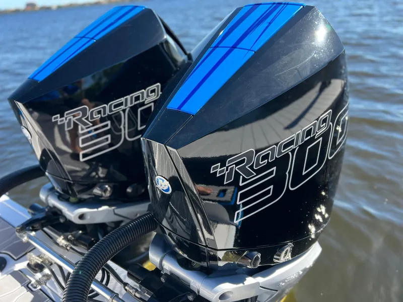Slide: The Image of Twin Mercury Racing 300 engines on a 2023 Sunsation 32 CCX boat, on water. - 24
