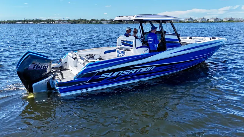 Slide: The Image of 2023 Sunsation 32 CCX boat on water, featuring sleek blue design and powerful engine. - 3