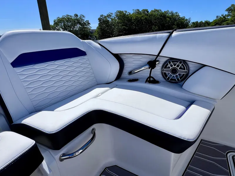 Slide: The Image of 2023 Sunsation 32 CCX boat interior with white seating, speaker, and cup holders. - 35