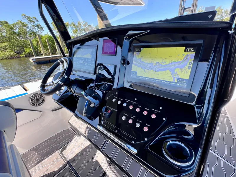 Slide: The Image of 2023 Sunsation 32 CCX boat dashboard with advanced navigation and control systems. - 41