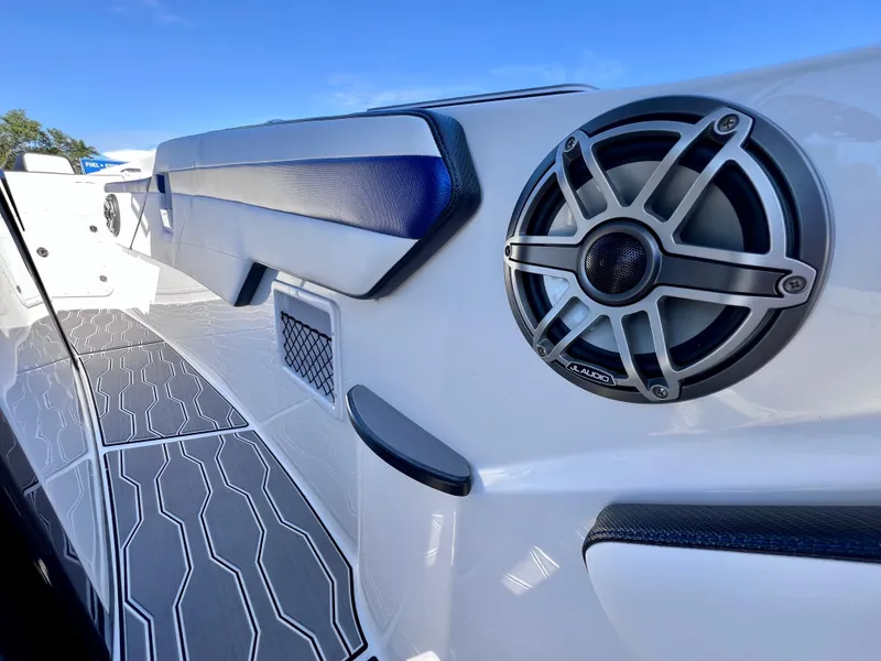 Slide: The Image of 2023 Sunsation 32 CCX boat interior with speaker and cushioned seating. - 54