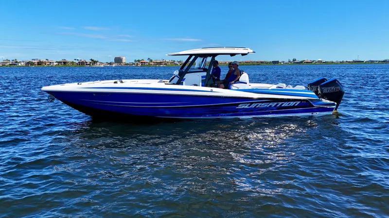 Slide: The Image of 2023 Sunsation 32 CCX boat cruising on open water under clear blue sky. - 8