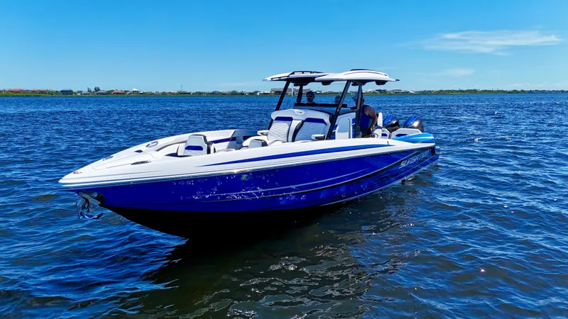 Slide: The Image of 2023 Sunsation 32 CCX boat on calm blue water under clear sky. - 9