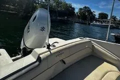 Slide: The Image of 2022 Stingray 191 DC boat interior with outboard motor on a sunny day. - 13