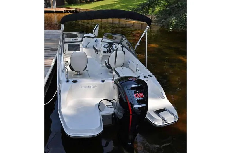 Slide: The Image of Manufacturer Provided Image: 2022 Stingray 191 DC boat docked with 115 HP Mercury outboard motor. - 6