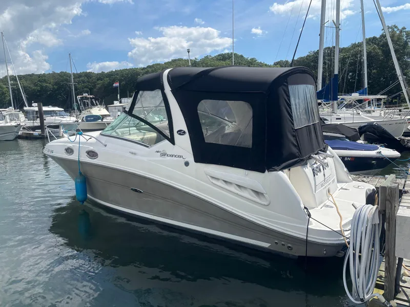 The Image of 2006 Sea Ray 260 Sundancer boat docked at marina under blue sky. - 0