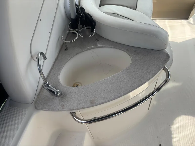 Slide: The Image of 2006 Sea Ray 260 Sundancer boat interior with sink and seating area. - 11