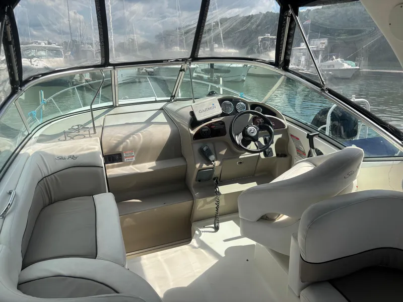 Slide: The Image of Interior of a 2006 Sea Ray 260 Sundancer boat with steering wheel and seating. - 12