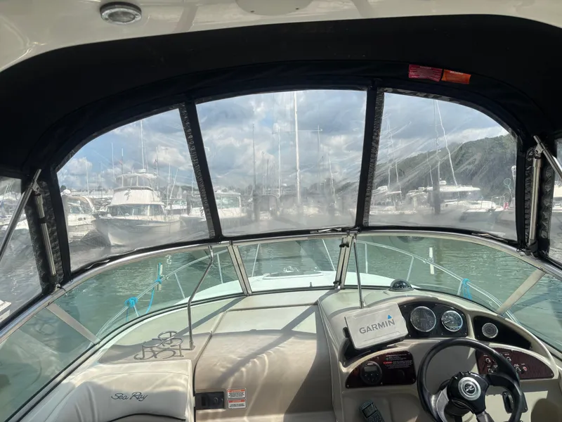 Slide: The Image of 2006 Sea Ray 260 Sundancer cockpit view with Garmin navigation, docked at marina. - 13