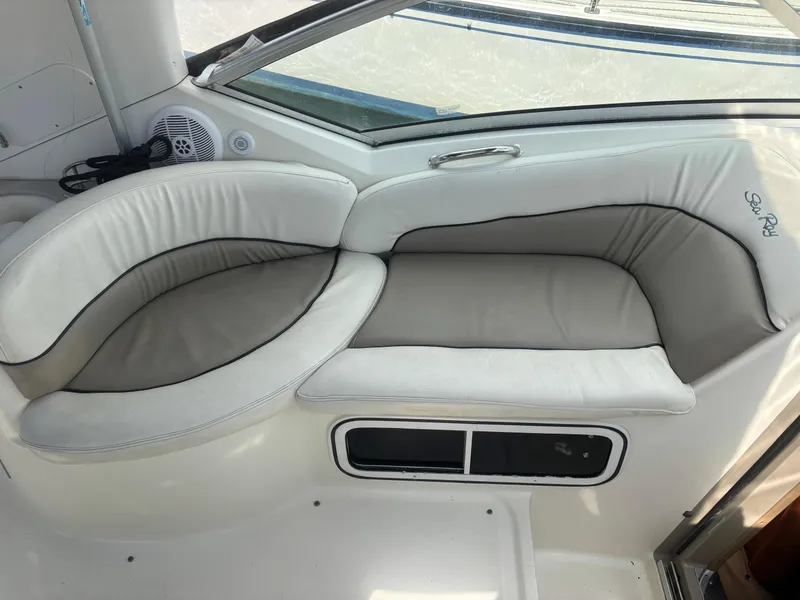 Slide: The Image of 2006 Sea Ray 260 Sundancer interior seating with white and gray upholstery. - 18