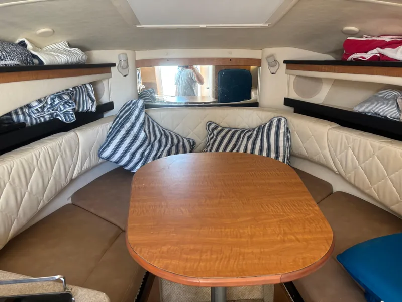 Slide: The Image of Interior of 2006 Sea Ray 260 Sundancer with cozy seating and striped cushions. - 19