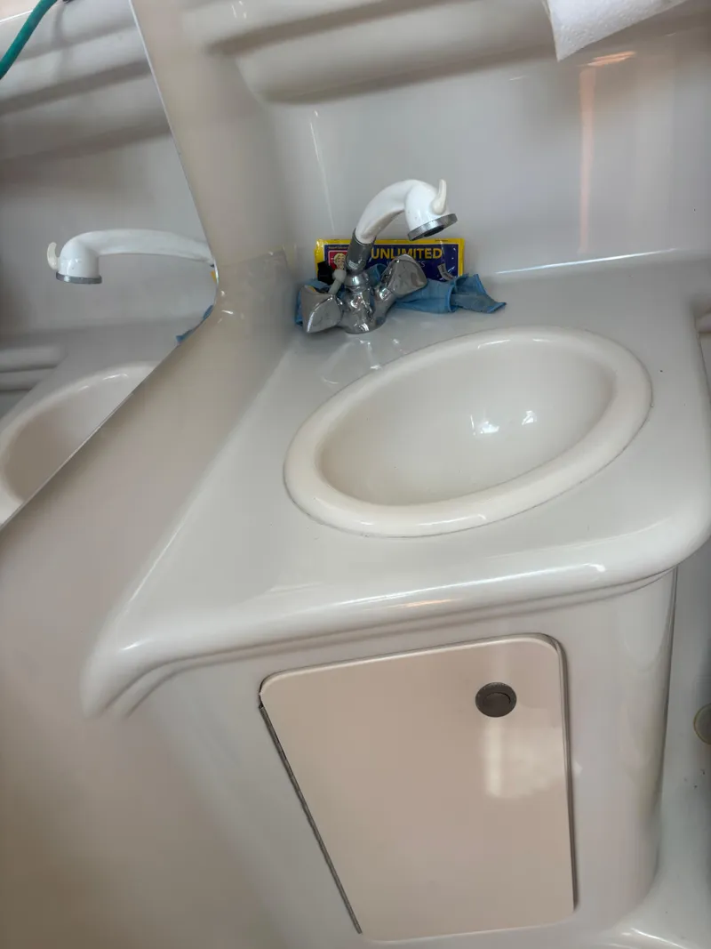 Slide: The Image of 2006 Sea Ray 260 Sundancer bathroom sink with faucet and storage cabinet. - 21
