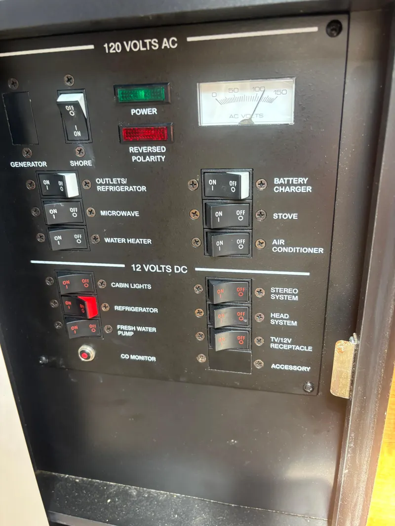 Slide: The Image of Electrical control panel of a 2006 Sea Ray 260 Sundancer boat, showing switches and indicators. - 25