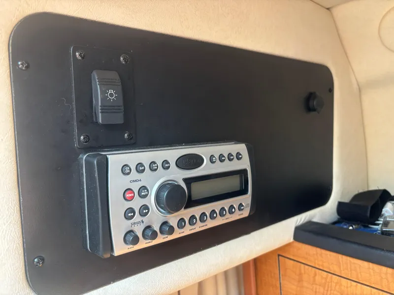 Slide: The Image of 2006 Sea Ray 260 Sundancer cabin stereo system with control panel and light switch. - 26