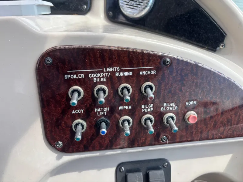 Slide: The Image of Control panel of a 2006 Sea Ray 260 Sundancer boat with labeled switches. - 28